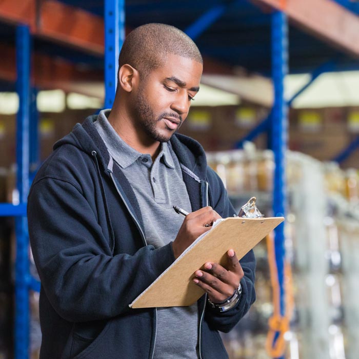 man doing inventory with clipboard